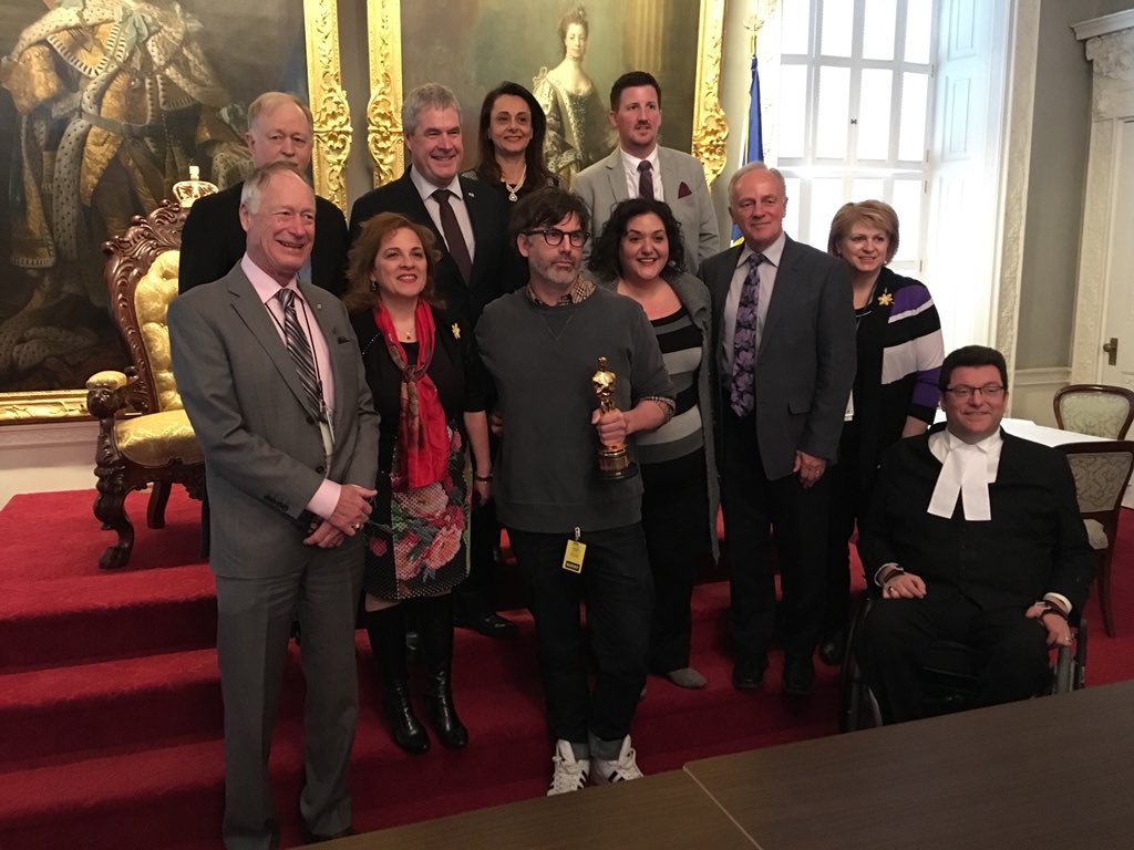 Shane Vieau, who won an Academy Award for his set design on The Shape of Water, poses with MLAs at the Nova Scotia legislature on April 4, 2019.