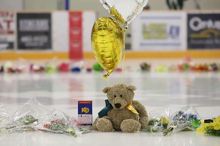 Flowers, cards and sentimental gifts adorn the ice surface at Humboldt Uniplex during preparations for a prayer vigil for the Humboldt Broncos hockey team, April 8, 2018.
