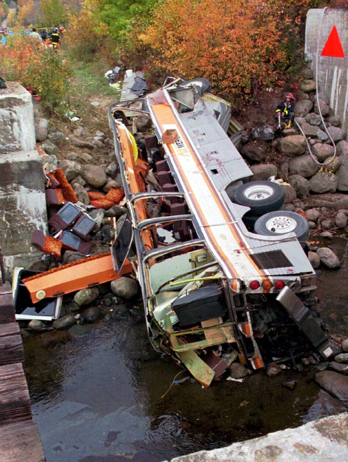 This Oct. 13, 1997, file photo, shows a bus on its side after it plunged into a ravine in Les Eboulements, northeast of Quebec City, killing 44 people.