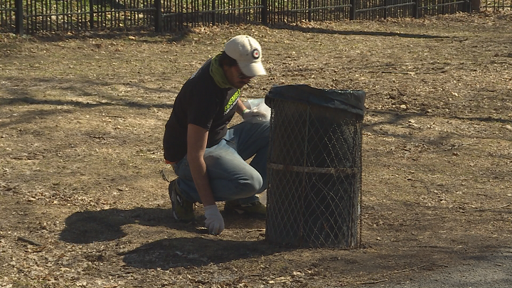A Montreal resident picks up trash in La Fontaine Park on Earth Day. Sunday, April 22, 2018.