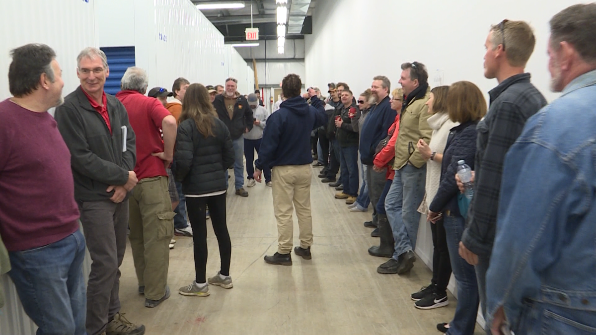 Eager participants await the opening of another storage unit. 