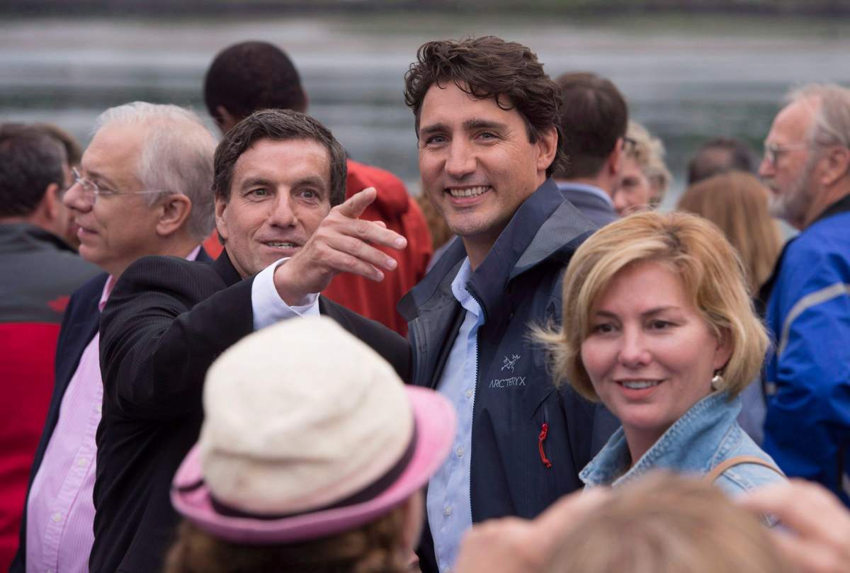 Former Liberal MP Denis Lemieux points out a landmark to Prime Minister Justin Trudeau as he welcomed Liberal MPs to his riding of Chicoutimi-Le Fjord for a caucus meeting in 2016. Lemieux would quit politics within weeks of that meeting.