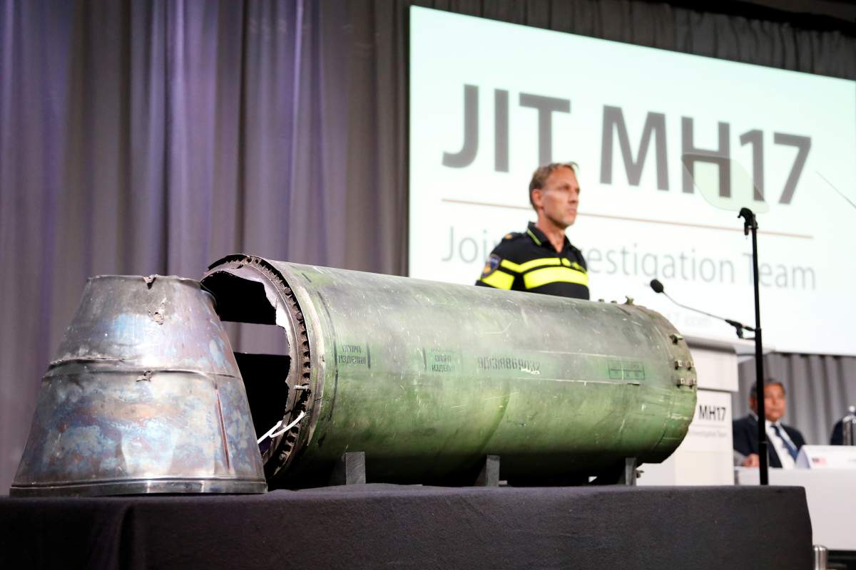 A damaged missile is displayed during a news conference by members of the Joint Investigation Team, who present interim results in the ongoing investigation of the 2014 MH17 crash that killed 298 people over eastern Ukraine.