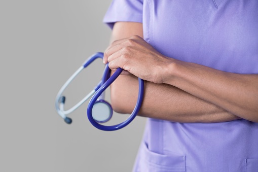 Female doctor holding stethoscope.