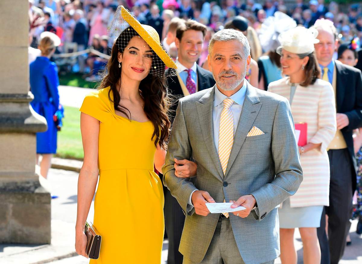 US actor George Clooney (R) and his wife British lawyer Amal Clooney (L) arrive for the wedding ceremony of Britain’s Prince Harry and actress Meghan Markle at St George’s Chapel, Windsor Castle, in Windsor, on May 19, 2018. (Photo by Odd ANDERSEN / various sources / AFP)