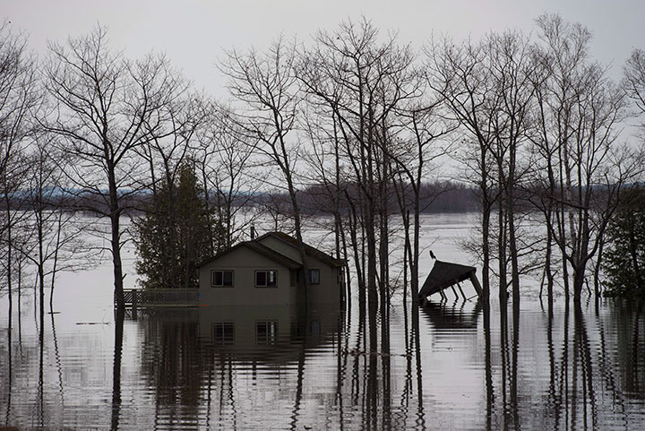 Homes and cottages are surrounded by rising floodwater from the Saint John River near Lakeville Corner, N.B. on Wednesday, May 2, 2018.