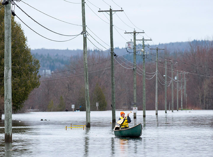 A resident paddles his canoe at Darlings Island, N.B. on Thursday, May 3, 2018.
