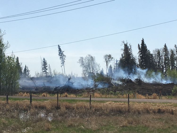 Crews continue to put out hot spots in Strathcona County on Tuesday, May 15, 2018.