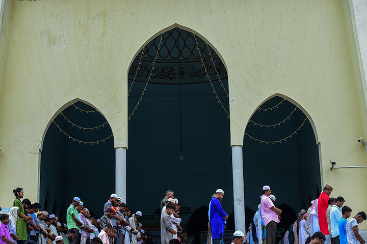 People offer prayers outside the National Mosque of Bangladesh in the capital of Dhaka on June 15, 2018.