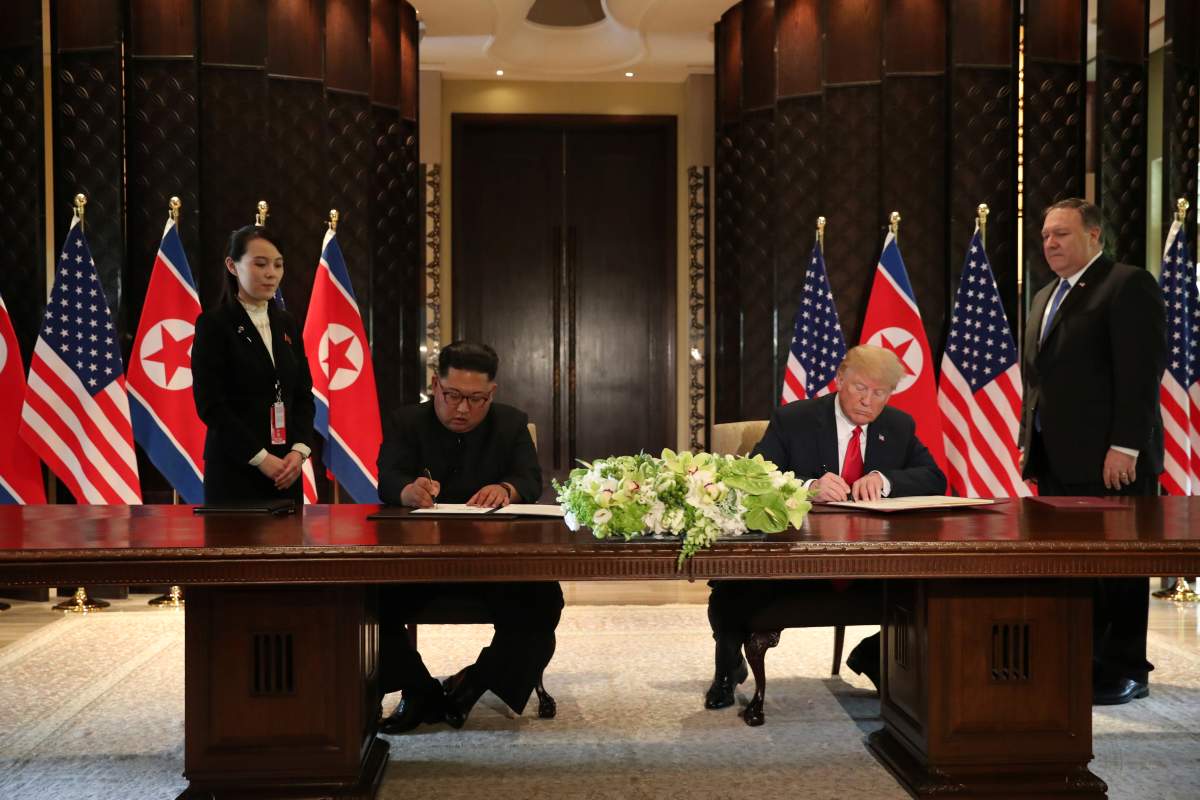 U.S. President Donald Trump and North Korea’s leader Kim Jong Un sign documents that acknowledge the progress of the talks and pledge to keep momentum going, after their summit at the Capella Hotel on Sentosa island in Singapore June 12, 2018.