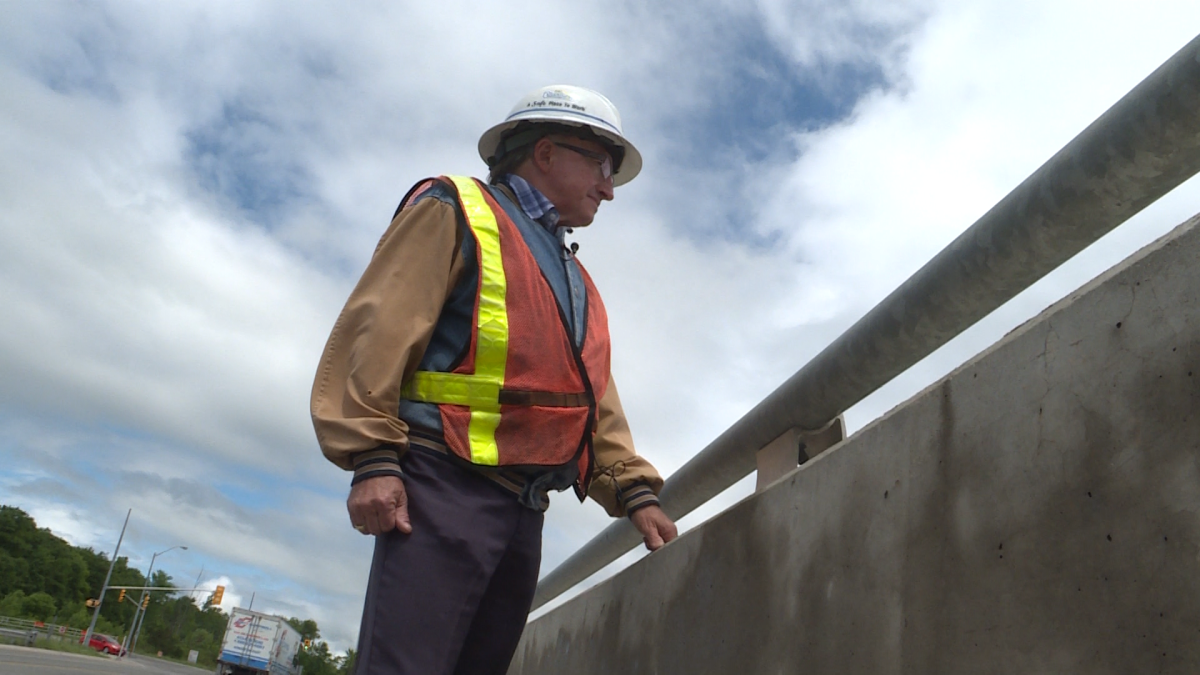 Owner of Corcoran Excavating, Dan Corcoran looks toward a 401 construction site from the Montreal Street overpass.