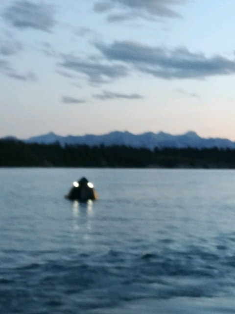 A blurry photo of a boat sinking on Ghost Lake, west of Calgary. Ten people had to be rescued because of it. July 14, 2018.