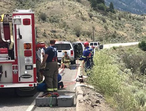 Emergency vehicles assemble following a single vehicle crash on Highway 3 in the South Okanagan Monday, July 9, 2018. 