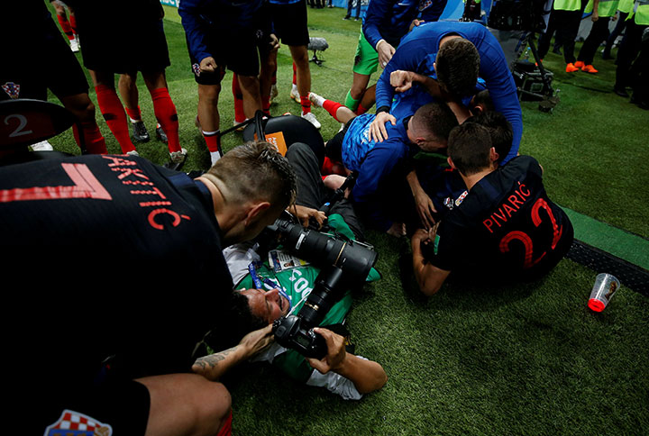 Croatia players celebrate next to an AFP photographer Yuri Cortez after Mario Mandzukic scores their second goal.
