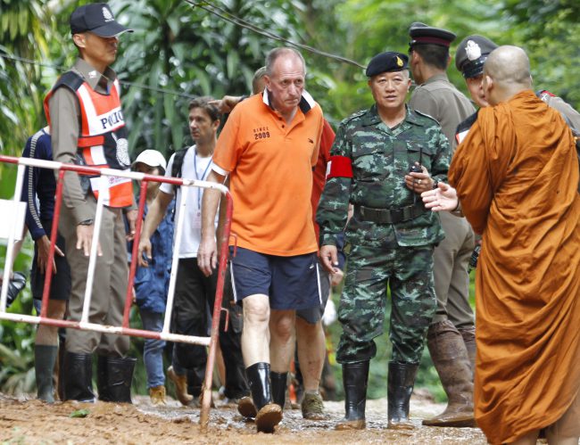 British cave diver Vern Unsworth walks next to a Thai soldier and policemen during the rescue operations for the youth soccer team and their coach, at the Tham Luang cave in Khun Nam Nang Non Forest Park, Chiang Rai province, Thailand, 30 June 2018