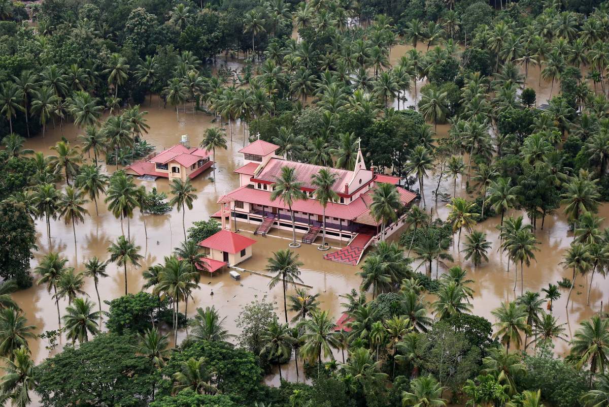 An aerial view shows partially submerged houses and church at a flooded area in the southern state of Kerala, India, August 17, 2018.
