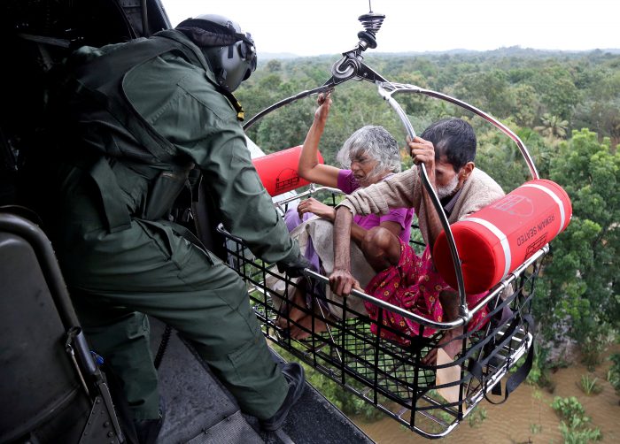 People are airlifted by the Indian Navy soldiers during a rescue operation at a flooded area in the southern state of Kerala, India, August 17, 2018.