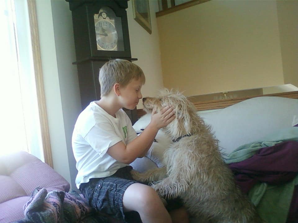 Ben Harris snuggles up to his dog, Pretzel.