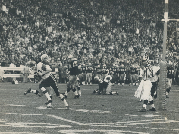 CANADA - NOVEMBER 28:  Busted play brings touchdown. Just as the second quarter began in today's Grey Cup game between B.C. field-goal attempt. Pete Ohler quickly straightened up with the skidding ball as Jim Karphin broke into the end zone. Ohler's pass beat Ti-Cats' Don Sutherin (22) and Lions led 13-0; later stretched out to 20-1.