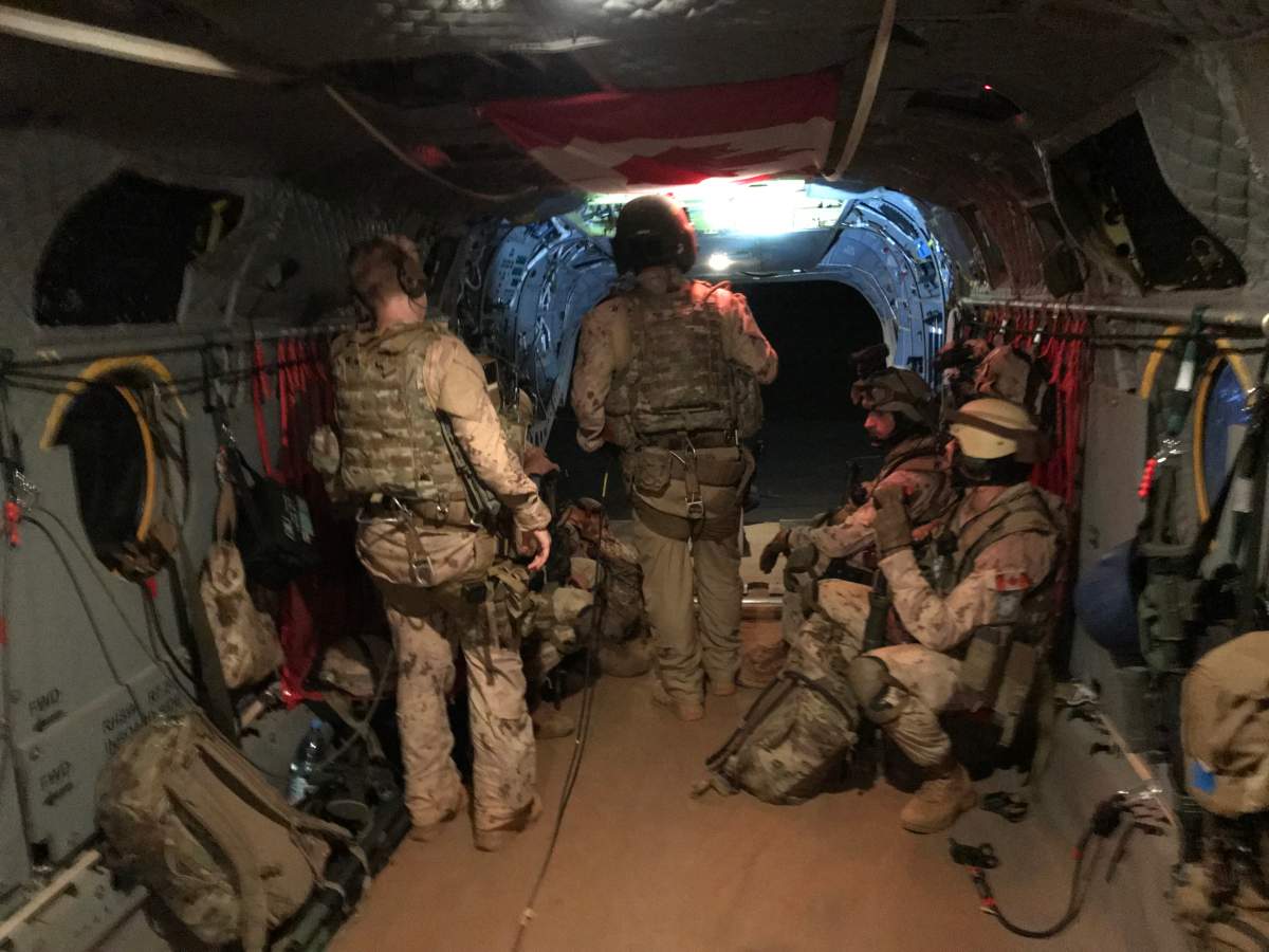 Canadians depart on a Chinook helicopter due to bad weather. 