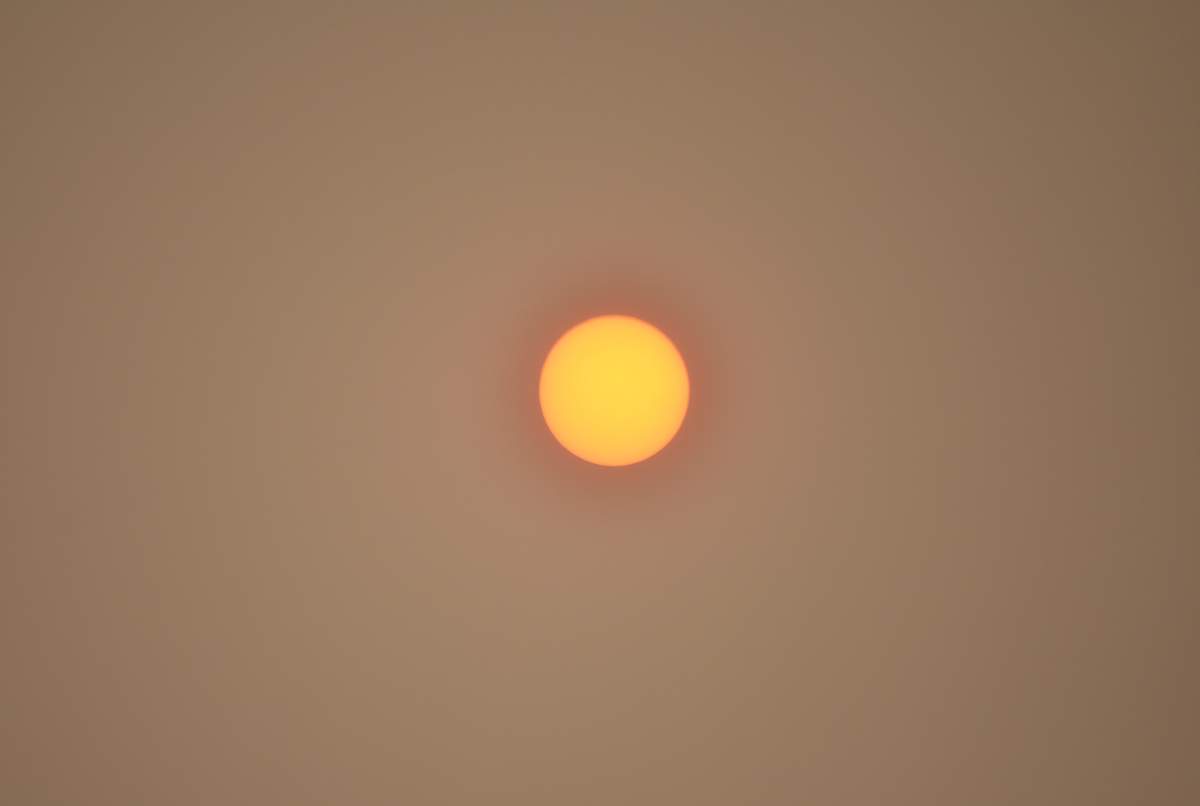 Orange sun shining through thick smoke in the air over southeast Edmonton on August 15, 2018.