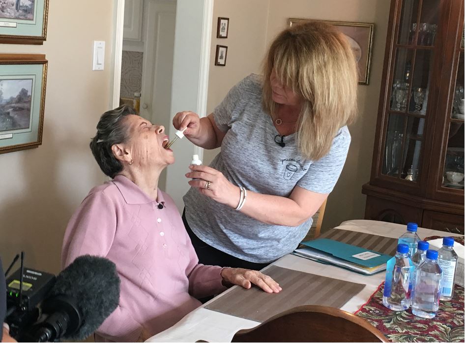 Linda Moreal giving her mother, Maria Moreal, her cannabinoid oil medication.