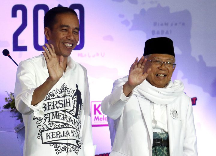 Indonesian incumbent presidential candidate Joko Widodo, left, and his running mate KH Ma’ruf Amin wave after they register for the 2019 presidential election at the General Election Commission office in Jakarta, Indonesia, on Aug. 10, 2018.
