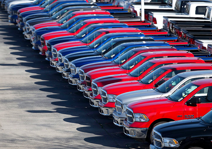 In this Jan. 5, 201, file photo, Ram pickup trucks are on display on the lot at Landmark Dodge Chrysler Jeep RAM in Morrow, Ga. 