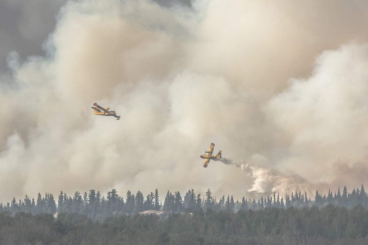 Water bombers attack the Shovel Lake wildfire on Saturday, Aug. 18, 2018.