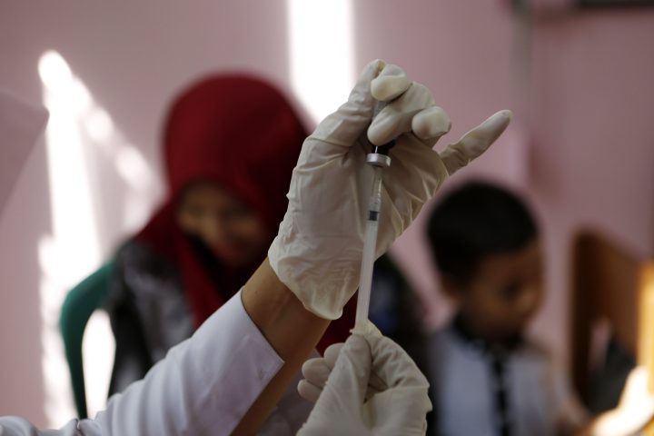An Indonesia Health Care officer prepares a vaccine for a child in Banda Aceh, Aceh, Indonesia, 12 December 2017. 