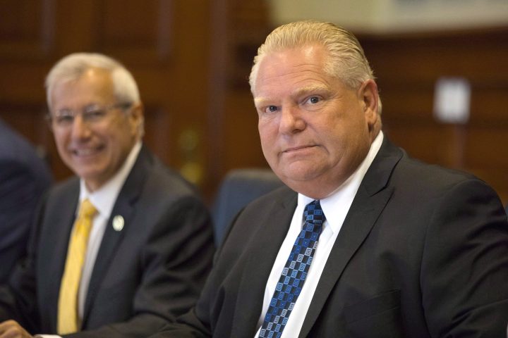 Ontario Premier Doug Ford, right, sits with then-Finance Minister Vic Fedeli at Queens Park on August 30, 2018.