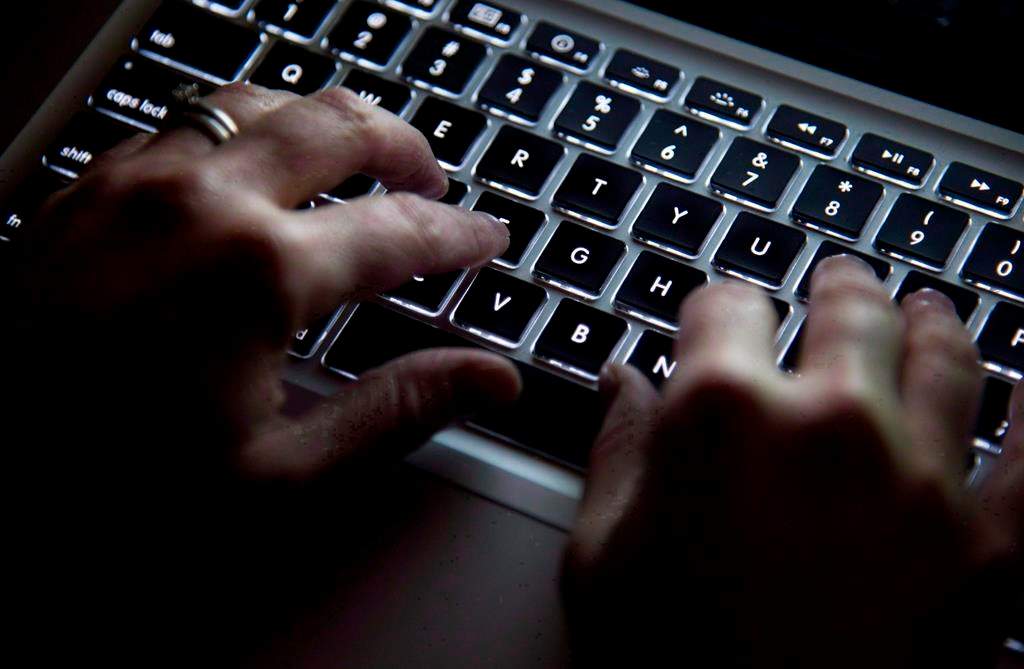 A woman types on a keyboard in Vancouver on Wednesday, December, 19, 2012.