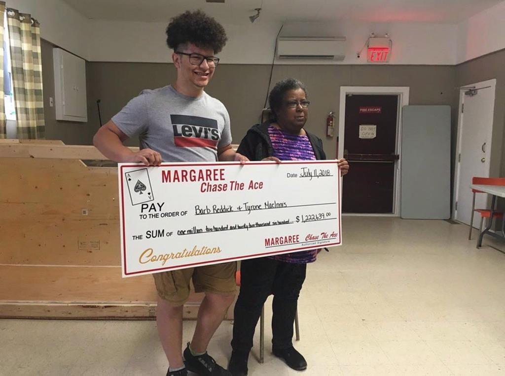 Tyrone MacInnis, left, and Barb Reddick, right, accept their Chase the Ace lottery prize in this undated handout photo. THE CANADIAN PRESS/HO, Bernice Curley, Chase The Ace Margaree
