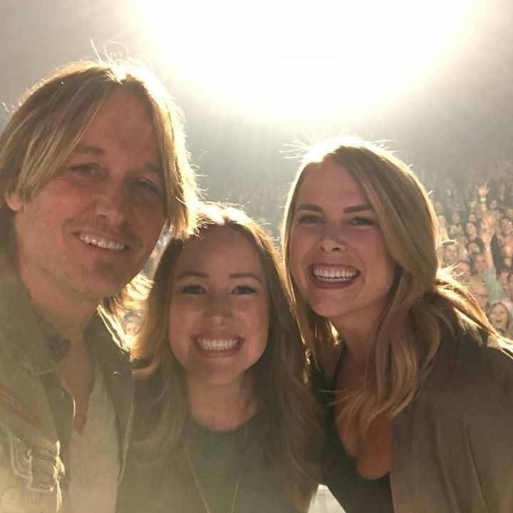 The coworkers take a selfie with Kieth Urban while on stage.