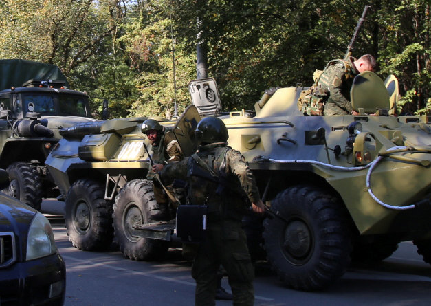 Law enforcement officers gather at the scene of a fatal attack on a college in the port city of Kerch, Crimea October 17, 2018.