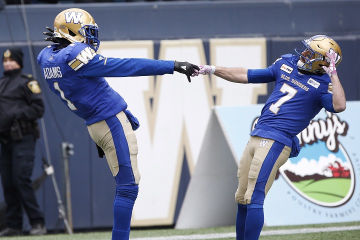 Winnipeg Blue Bombers' Darvin Adams (1) and Weston Dressler (7) celebrate Adams' touchdown against the Saskatchewan Roughriders during the first half of CFL action in Winnipeg Saturday, October 13, 2018. 