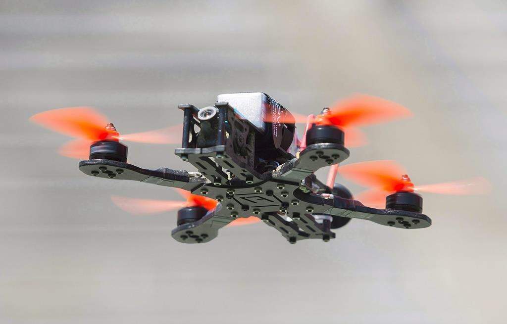 A drone hovers over the course during the Montreal drone expo, Saturday, June 25, 2016. THE CANADIAN PRESS/Graham Hughes.