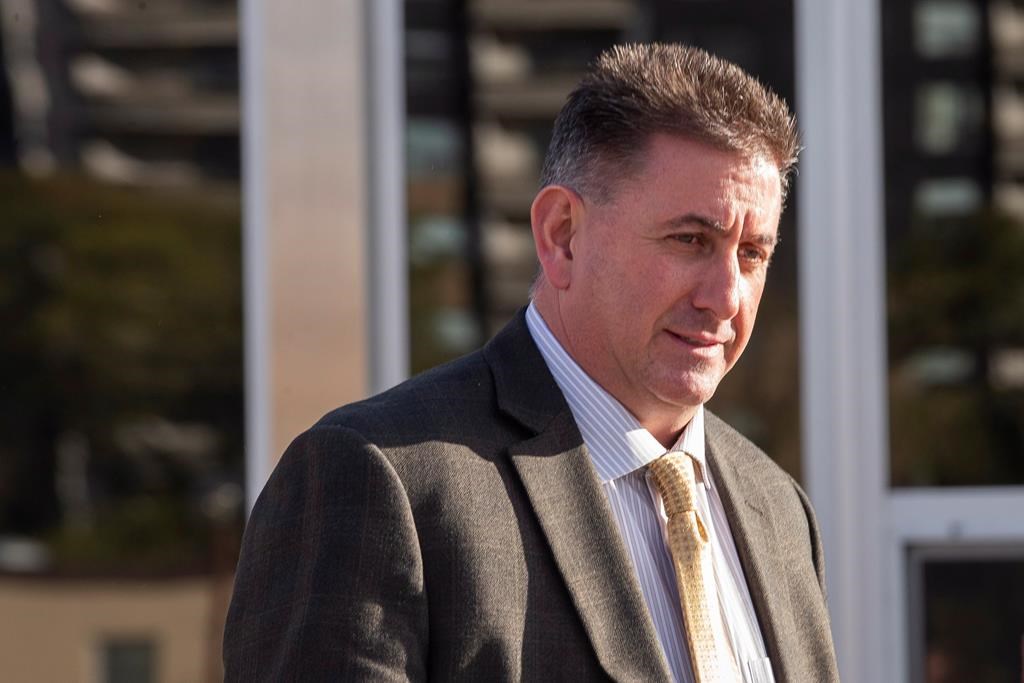 Former gymnastics coach Dave Brubaker, right, leaves the court house in Sarnia, Ont., Tuesday, October 23, 2018 following the first day of testimony in his sexual assault trial. THE CANADIAN PRESS/Geoff Robins.
