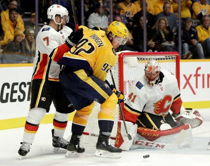 Calgary Flames goaltender Mike Smith (41) blocks a shot by Nashville Predators center Ryan Johansen (92) in the second period of an NHL hockey game Tuesday, Oct. 9, 2018, in Nashville, Tenn.