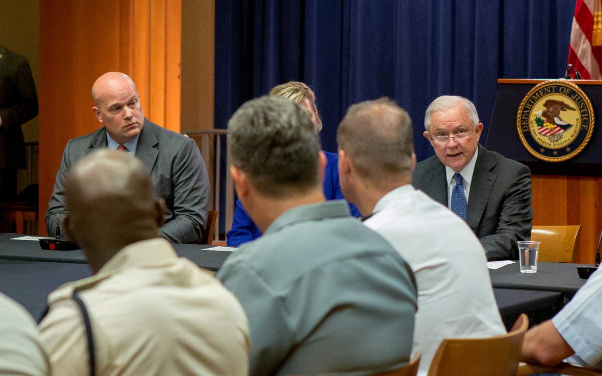 Chief of Staff to the Attorney General Matthew Whitaker (L) looks over at U.S. Attorney General Jeff Sessions during a roundtable discussion with foreign liaison officers at the Justice Department in Washington, U.S., August 29, 2018.
