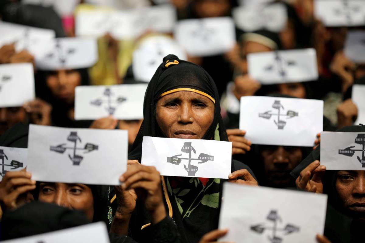 Rohingya refugee women hold placards as they take part in a protest at the Kutupalong refugee camp to mark the one-year anniversary of their exodus in Cox's Bazar, Bangladesh, August 25, 2018. 