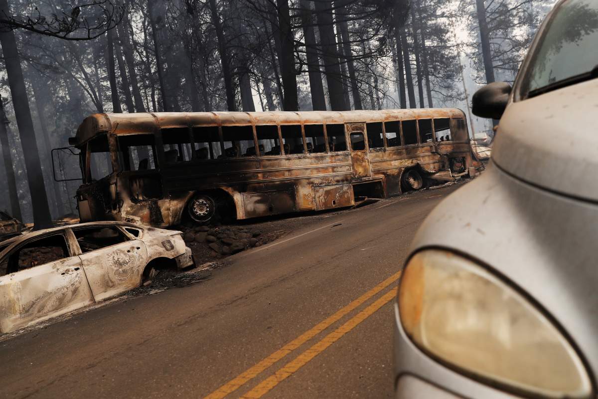 An abandoned and burned school bus is seen on Skyway during the Camp Fire in Paradise, California, U.S. November 9, 2018.