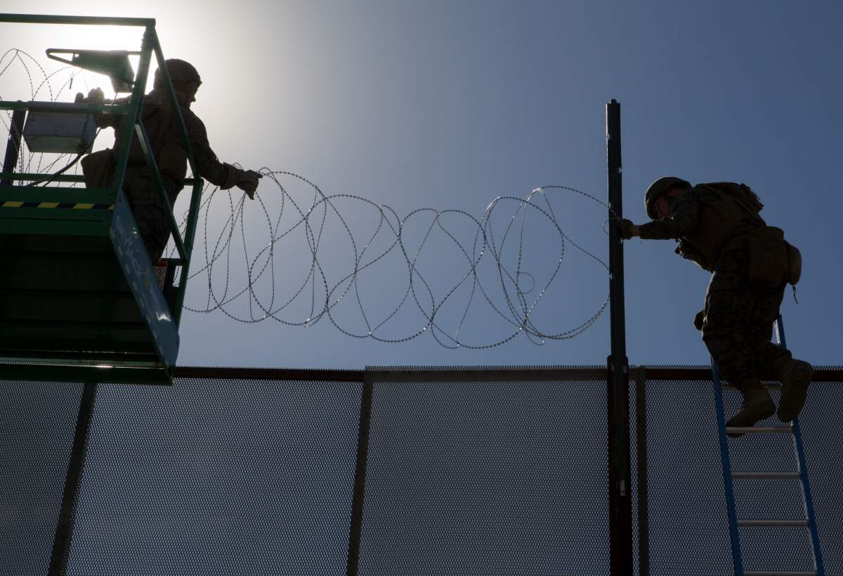U.S. Marines with 7th Engineer Support Battalion, Special Purpose Marine Air-Ground Task Force 7, secure concertina wire along the California-Mexico border at the Otay Mesa Port of Entry in California, U.S., November 12, 2018.