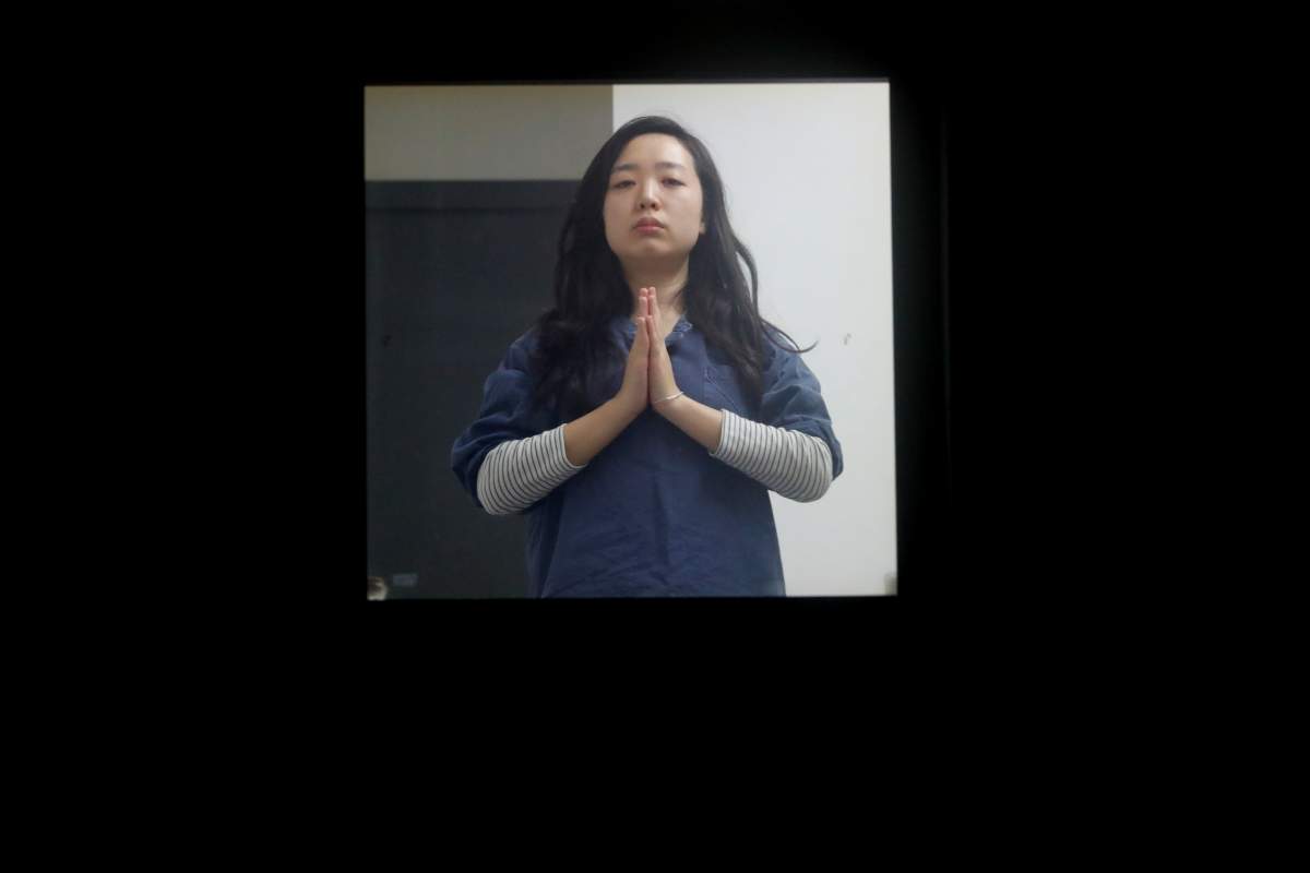 Park Hye-ri, 28, a startup business program manager, stretches while being locked inside a cell of Prison Inside Me, a mock prison facility, in Hongcheon, South Korea, November 11, 2018.