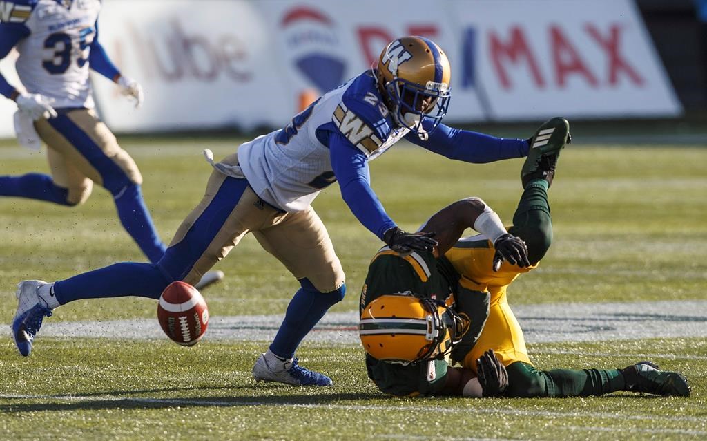 Winnipeg Blue Bombers Anthony Gaitor (23) tackles Edmonton Eskimos Godfrey Onyeka (23) during first half CFL action in Edmonton, Alta., on Saturday November 3, 2018. THE CANADIAN PRESS/Jason Franson.