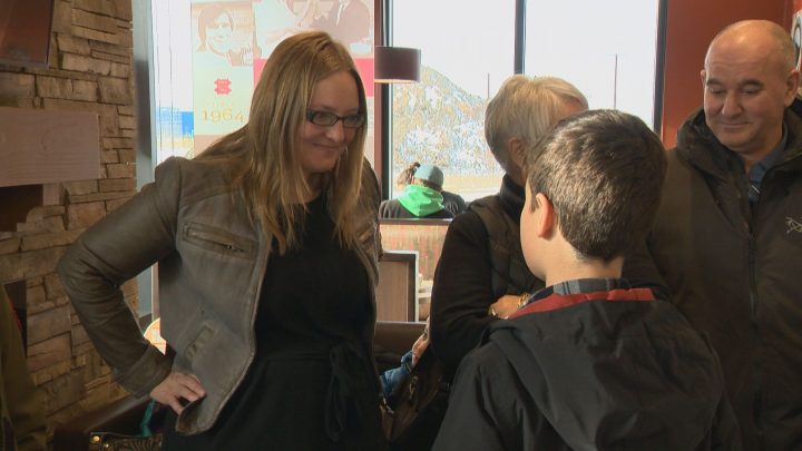 Dionne Miazdyck-Shield, executive director of the Saskatoon Society for the Protection of Children, talks with Eli Kearley.