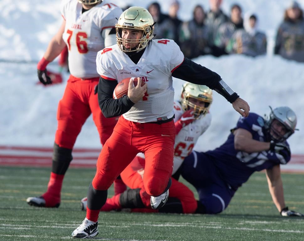 Laval University Rouge et Or's quarterback Hugo Richard runs to a first down against Western University Mustangs during second quarter action of the Vanier Cup final Saturday, November 24, 2018 in Quebec City.