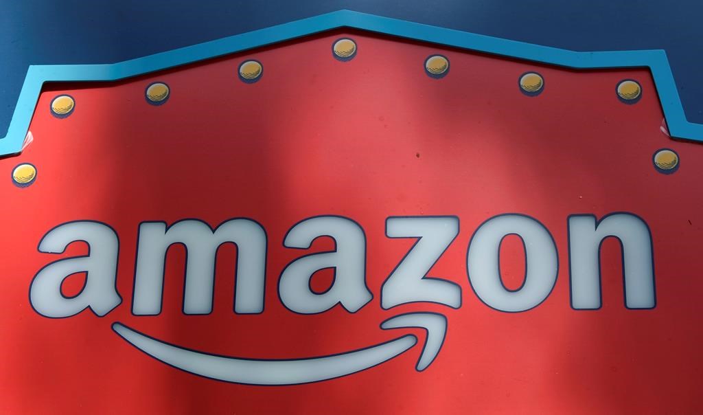 FILE - This Oct. 23, 2018, file photo shows an Amazon logo atop the Amazon Treasure Truck The Park DTLA office complex in downtown Los Angeles. Whether you've bought shoes at Zappos, picked up milk at Whole Foods or listened to an audiobook on Audible, you've been caught up in Amazon's growing web of businesses. And now, Amazon's sprawling empire will stretch even further. The company is expected to announce Tuesday, Nov. 13, that it will open two more bases outside of its Seattle headquarters: one in Crystal City in northern Virginia and the other in New York's Long Island City neighborhood. (AP Photo/Richard Vogel, File).