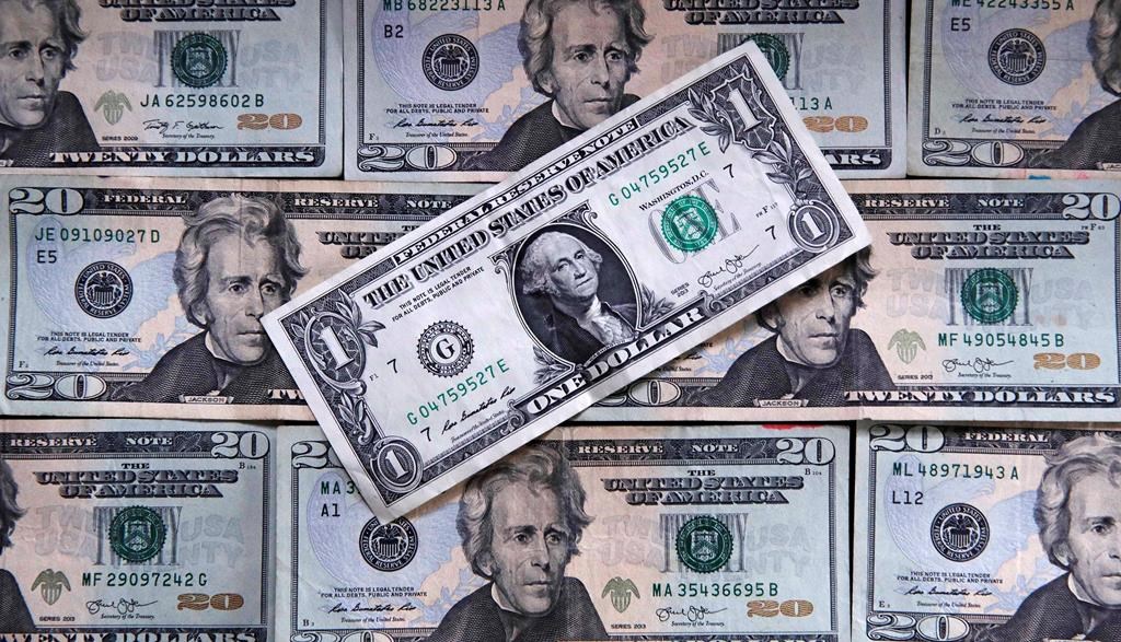 FILE- This June 15, 2018, file photo shows U.S. currency on a counter in East Derry, N.H. Most financial planners advise never tapping retirement savings to pay for your kid‚Äôs education. Even as college costs climb, there are still options to borrow that cash, whereas it's often noted that you can‚Äôt borrow for retirement. (AP Photo/Charles Krupa, File).