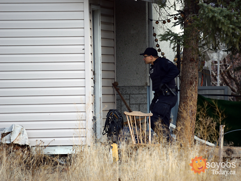 A police officer searches the scene.